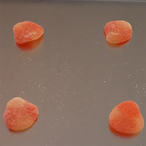 Four Haribo Peaches on a freeze dry tray. 