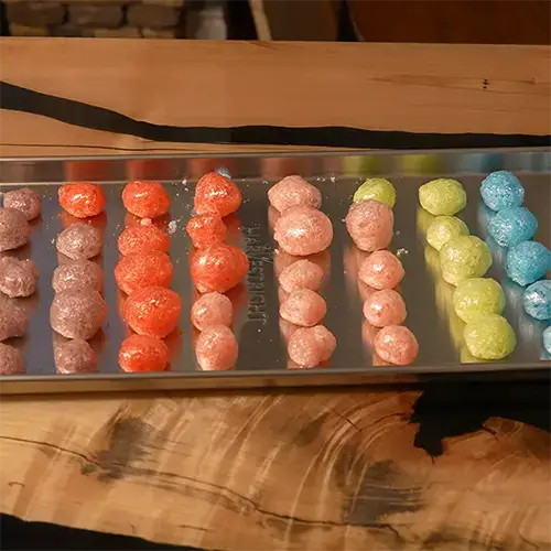 Rows of colorful freeze dried Jolly Ranchers placed neatly on a medium Harvest Right freeze dryer tray.