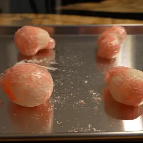 Four puffed up freeze dried Haribo Peaches on a freeze dry tray. 