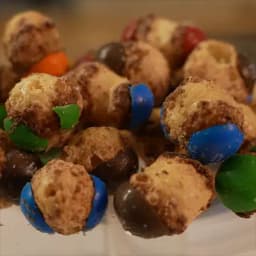 A group of freeze dried Caramel M&M's stacked on top of each other showing the texture of each one.