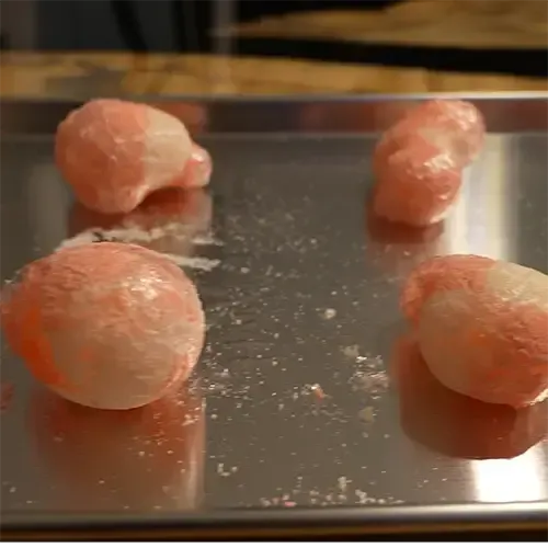 Four puffed up freeze dried Haribo Peaches on a freeze dry tray.