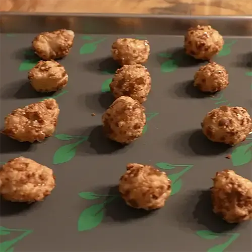 Twelve freeze dried Milk Duds stacked neatly on a medium Harvest Right freeze drying tray.