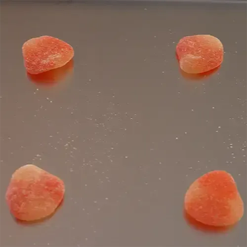 Four Haribo Peaches on a freeze dry tray.
